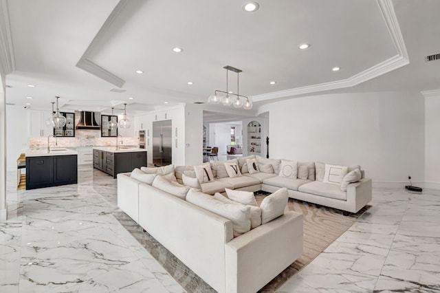 living room featuring recessed lighting, a raised ceiling, and crown molding