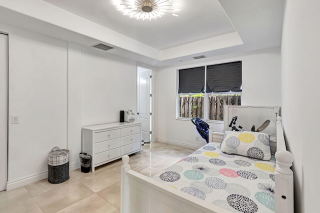 bedroom featuring baseboards, visible vents, a raised ceiling, and light tile patterned flooring