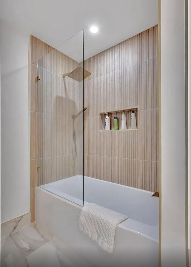 full bathroom featuring marble finish floor and shower / tub combination