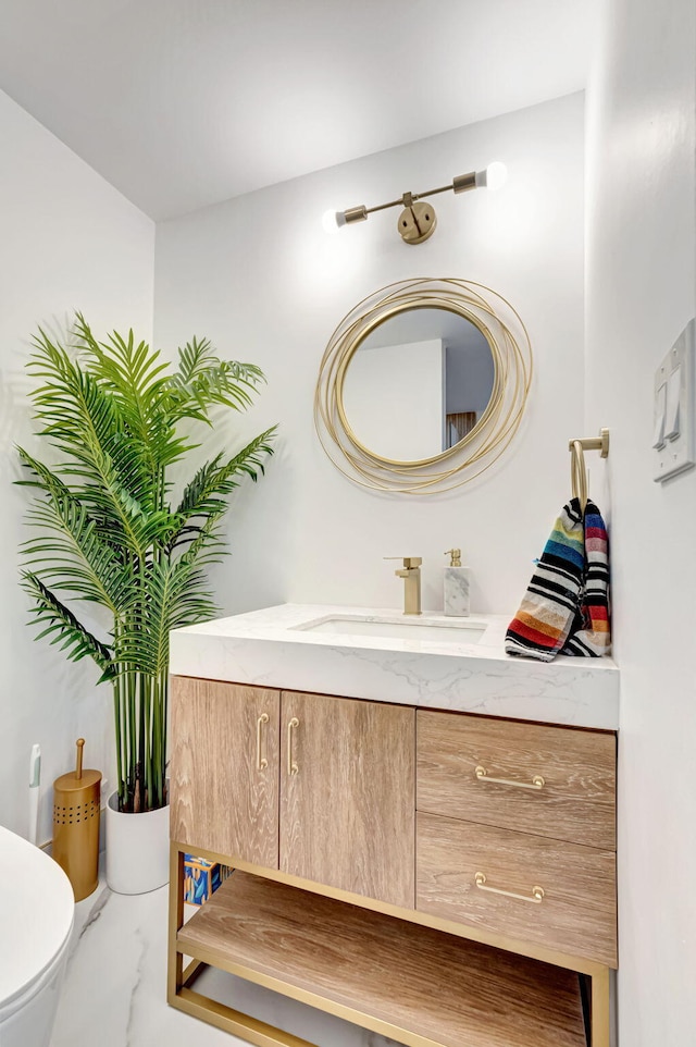 bathroom featuring marble finish floor, vanity, and toilet