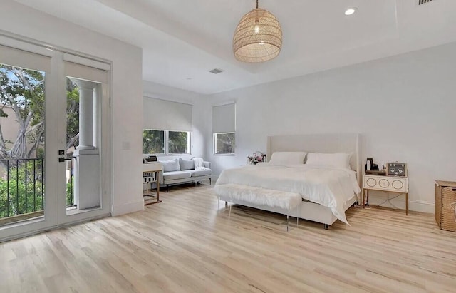 bedroom with access to exterior, recessed lighting, baseboards, and wood finished floors