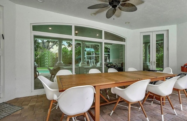 sunroom / solarium featuring a ceiling fan and french doors