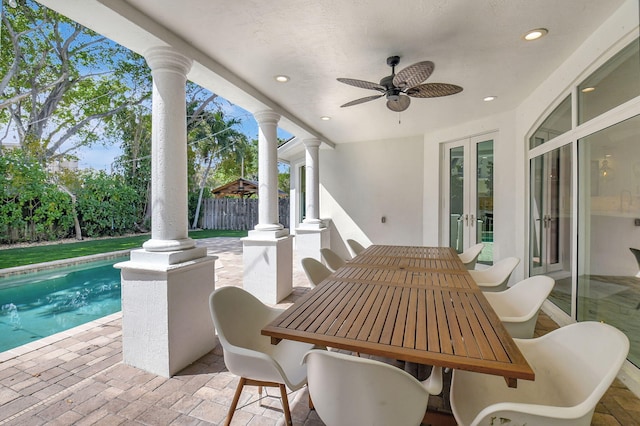 view of patio featuring a fenced in pool, french doors, outdoor dining area, a ceiling fan, and fence