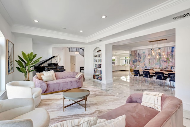 living room featuring built in features, stairs, marble finish floor, an inviting chandelier, and crown molding