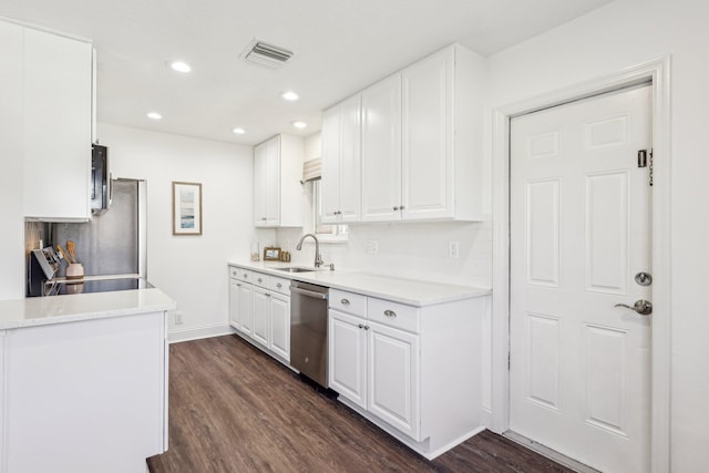 kitchen with dark wood-style floors, visible vents, a sink, white cabinets, and stainless steel dishwasher