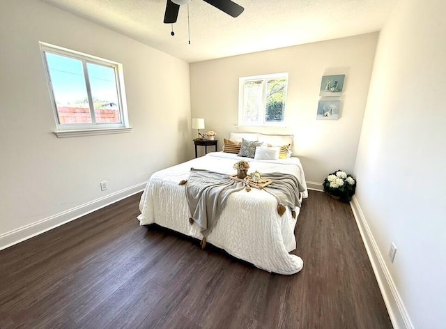 bedroom featuring multiple windows, baseboards, and dark wood-style flooring