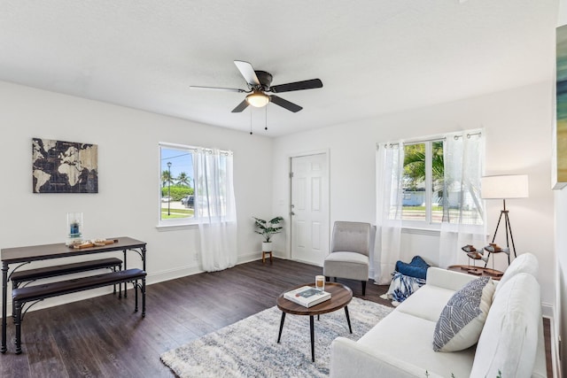 living room with a wealth of natural light, baseboards, wood finished floors, and ceiling fan