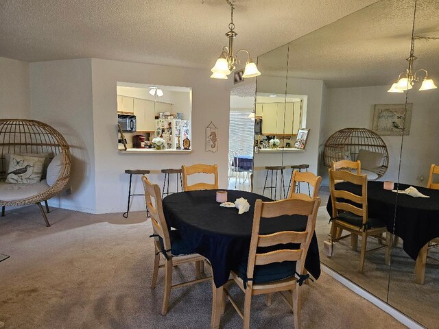 carpeted dining area featuring a textured ceiling and an inviting chandelier