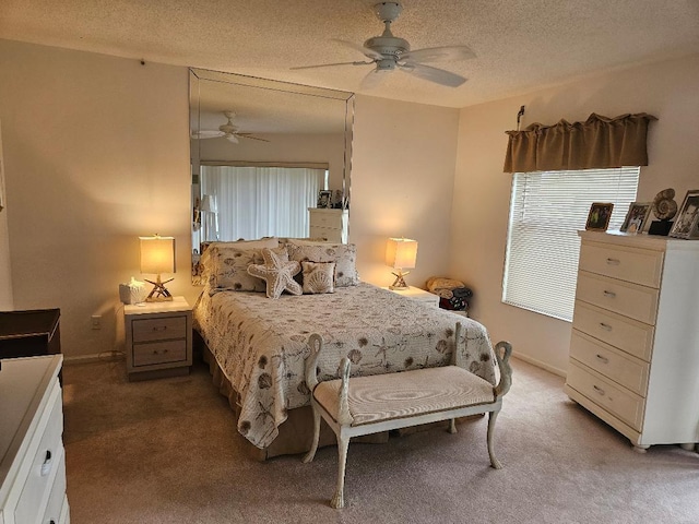 carpeted bedroom featuring a textured ceiling, ceiling fan, and baseboards