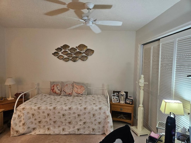 carpeted bedroom featuring a closet, ceiling fan, and a textured ceiling