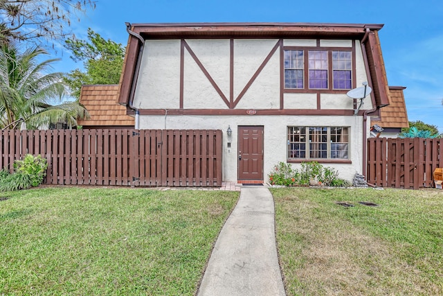 154 Weybridge Cir Unit C, Royal Palm Beach, FL 33411 - view of front facade with stucco siding, fence, and a front lawn