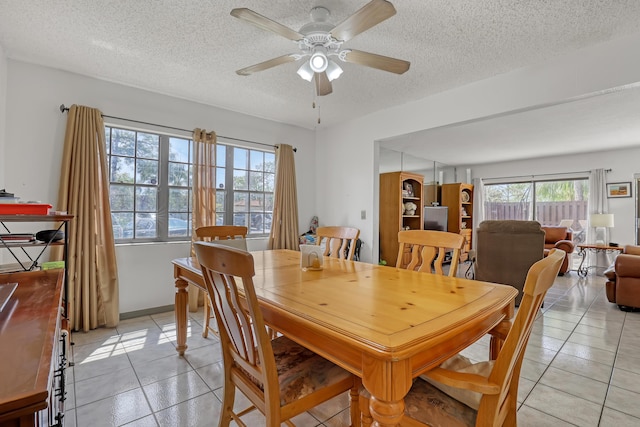 154 Weybridge Cir Unit C, Royal Palm Beach, FL 33411 - dining room featuring a ceiling fan, light tile patterned floors, baseboards, and a textured ceiling