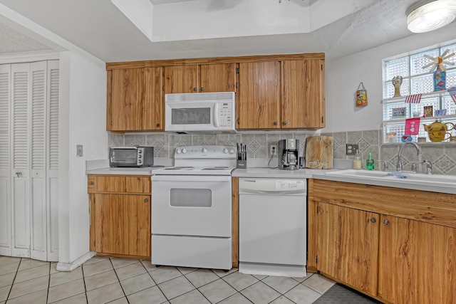 154 Weybridge Cir Unit C, Royal Palm Beach, FL 33411 - kitchen with light countertops, tasteful backsplash, white appliances, light tile patterned floors, and a sink