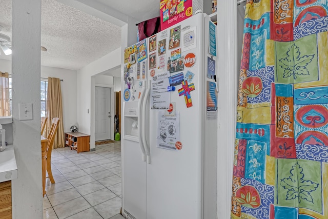 154 Weybridge Cir Unit C, Royal Palm Beach, FL 33411 - kitchen with light tile patterned floors, white fridge with ice dispenser, and a textured ceiling