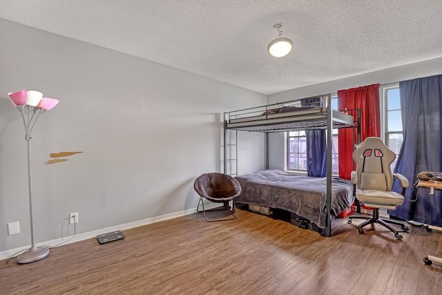 154 Weybridge Cir Unit C, Royal Palm Beach, FL 33411 - bedroom featuring baseboards, a textured ceiling, and wood finished floors