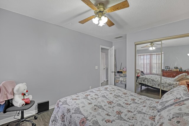 154 Weybridge Cir Unit C, Royal Palm Beach, FL 33411 - bedroom featuring a closet, a textured ceiling, visible vents, ceiling fan, and wood finished floors