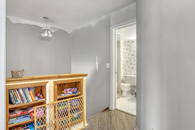 154 Weybridge Cir Unit C, Royal Palm Beach, FL 33411 - corridor featuring a textured ceiling and wood finished floors