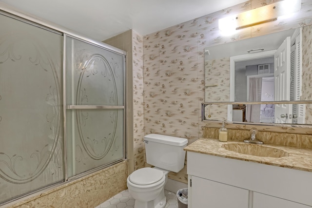 154 Weybridge Cir Unit C, Royal Palm Beach, FL 33411 - full bathroom featuring toilet, vanity, tile patterned flooring, wallpapered walls, and shower / bath combination with glass door