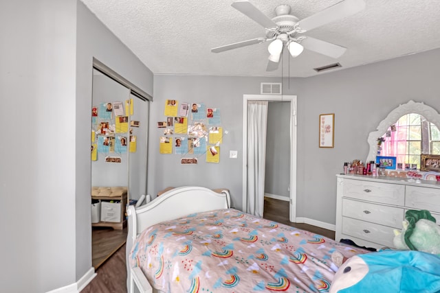 154 Weybridge Cir Unit C, Royal Palm Beach, FL 33411 - bedroom featuring a textured ceiling, visible vents, a ceiling fan, and wood finished floors