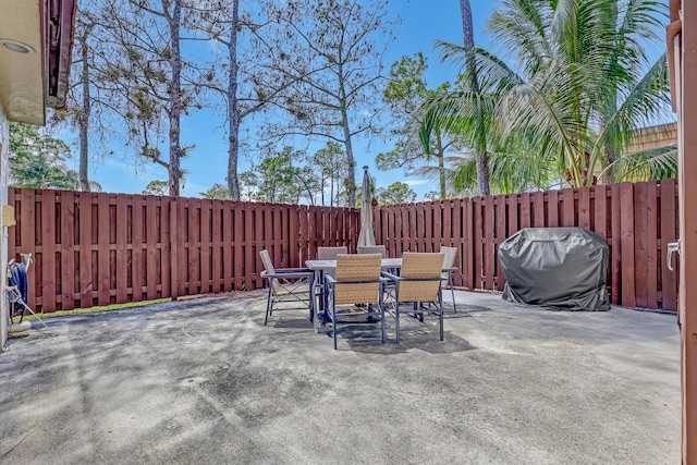 154 Weybridge Cir Unit C, Royal Palm Beach, FL 33411 - view of patio / terrace with a fenced backyard, outdoor dining space, and grilling area