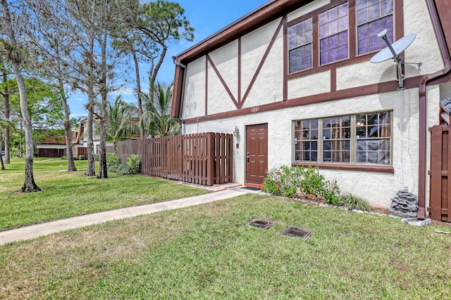 154 Weybridge Cir Unit C, Royal Palm Beach, FL 33411 - exterior space featuring stucco siding, fence, and a front yard