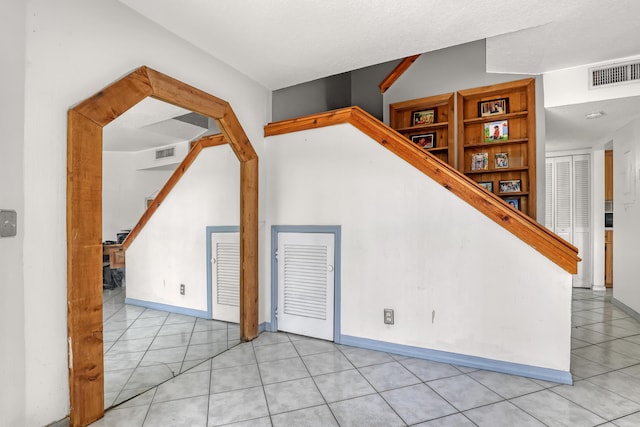 154 Weybridge Cir Unit C, Royal Palm Beach, FL 33411 - bonus room featuring baseboards, visible vents, stairway, and light tile patterned floors