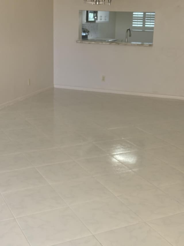 unfurnished room with a sink and baseboards