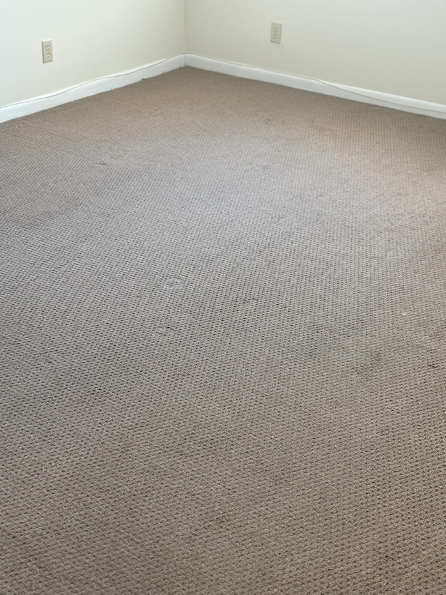 interior space featuring carpet and baseboards