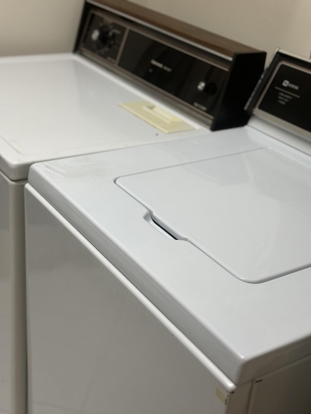 clothes washing area featuring laundry area and separate washer and dryer