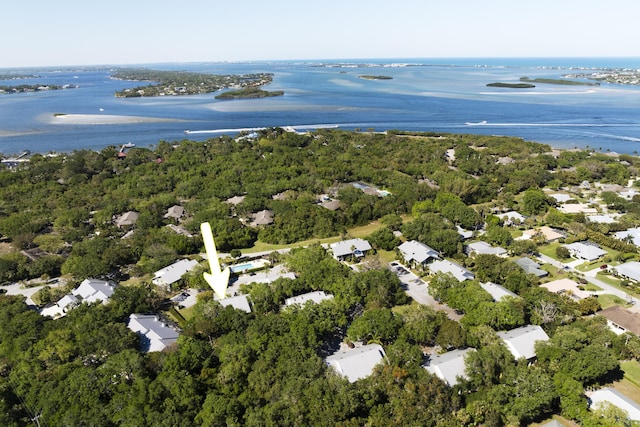 birds eye view of property with a forest view and a water view