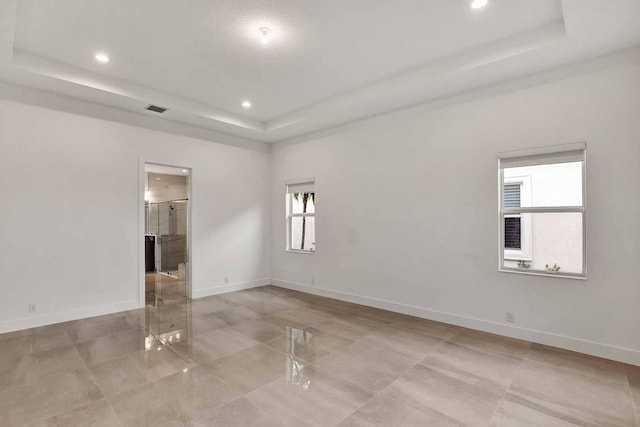 10033 Driftwood Way, Palm Beach Gardens, FL 33412 - spare room featuring a tray ceiling, recessed lighting, and baseboards