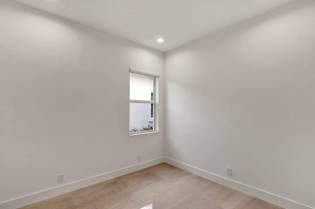 unfurnished room featuring recessed lighting and baseboards