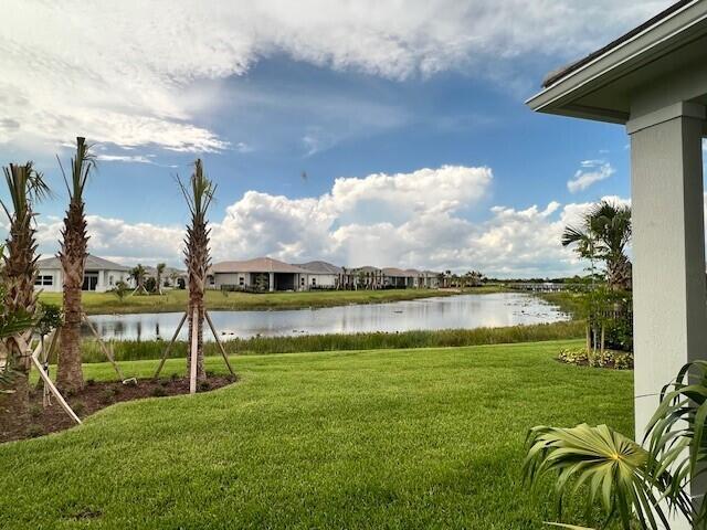 10033 Driftwood Way, Palm Beach Gardens, FL 33412 - view of green lawn featuring a water view and a residential view