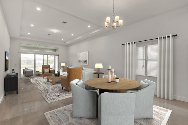 dining room featuring baseboards, a raised ceiling, a notable chandelier, and recessed lighting