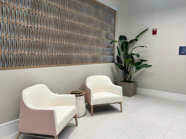 living area with baseboards and tile patterned floors