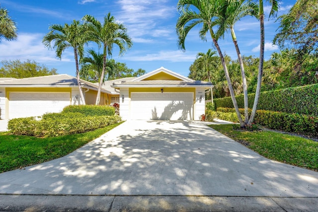 ranch-style house with driveway and a garage