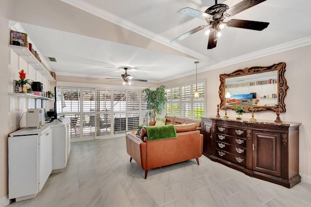 living area with ornamental molding, visible vents, and ceiling fan