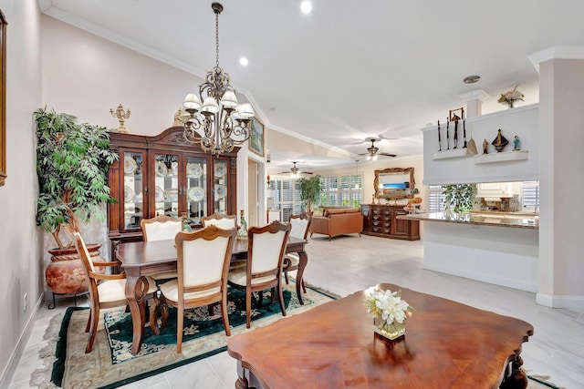 dining area featuring ceiling fan with notable chandelier, baseboards, and crown molding