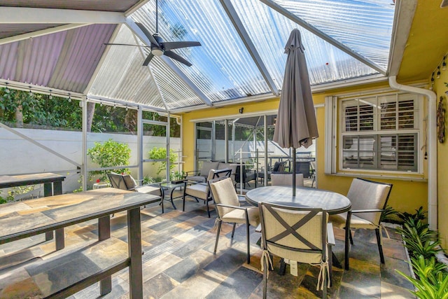 sunroom with ceiling fan and vaulted ceiling