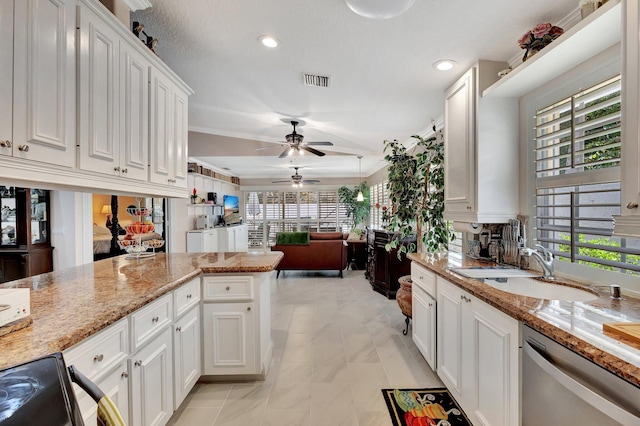 kitchen featuring stainless steel dishwasher, plenty of natural light, visible vents, and white cabinetry