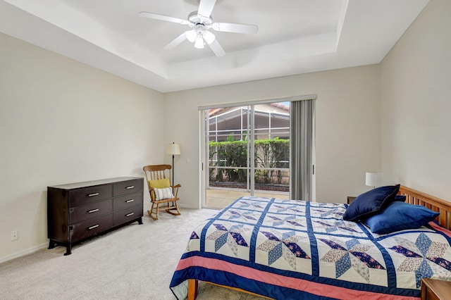 bedroom with access to outside, baseboards, a raised ceiling, and light colored carpet