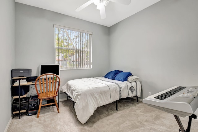 carpeted bedroom featuring a ceiling fan and baseboards