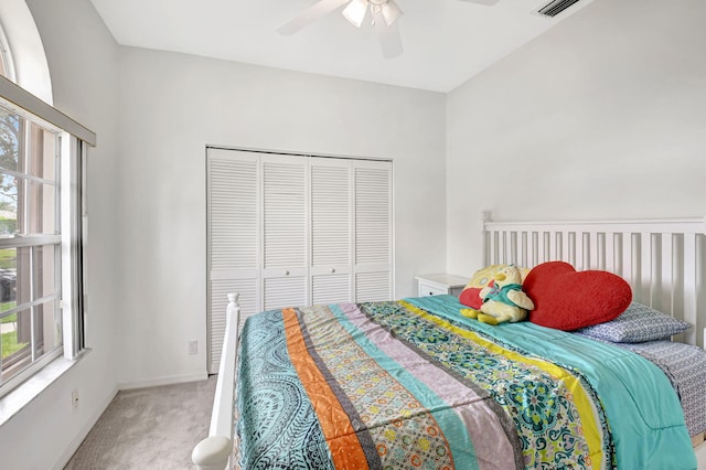 bedroom featuring a closet, multiple windows, baseboards, and carpet flooring