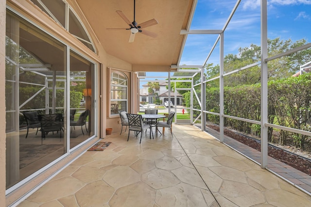 unfurnished sunroom with lofted ceiling and ceiling fan