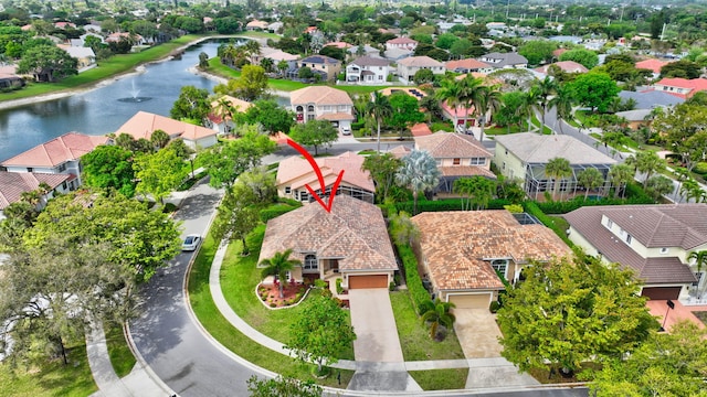 drone / aerial view featuring a water view and a residential view