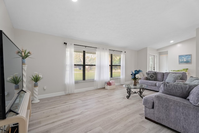 living room with recessed lighting, baseboards, light wood-type flooring, and lofted ceiling