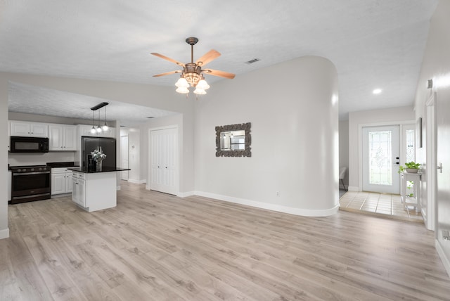 361 SW Carter Ave, Port Saint Lucie, FL 34983 - unfurnished living room with baseboards, light wood-style floors, ceiling fan, recessed lighting, and lofted ceiling