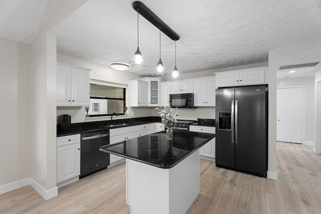 kitchen with white cabinetry, light wood-style floors, black microwave, dishwasher, and refrigerator with ice dispenser