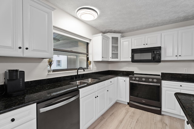 kitchen with a sink, white cabinets, black microwave, range with electric stovetop, and dishwasher