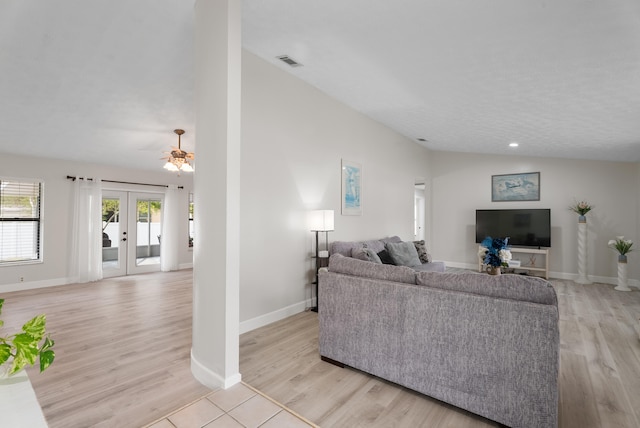 361 SW Carter Ave, Port Saint Lucie, FL 34983 - living room featuring french doors, light wood-type flooring, baseboards, and lofted ceiling